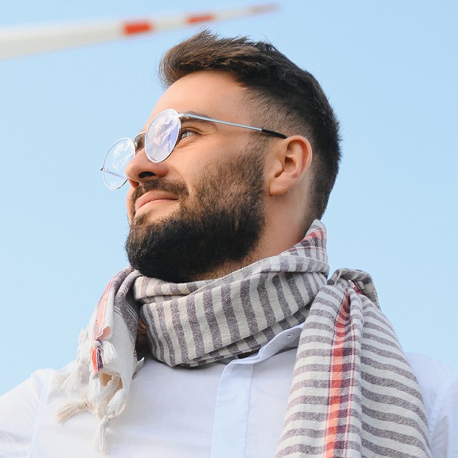 arab-man-standing-with-wind-turbine-on-mountain-WQBTLYT.jpg